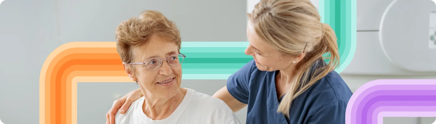 An older adult and a nurse in conversation, wrapped in the Joji ribbon motif