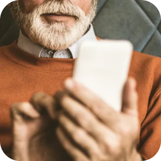 An older man reading his health records on a phone